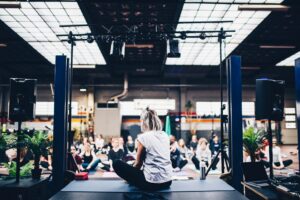 Woman delivering an event to people on yoga mats