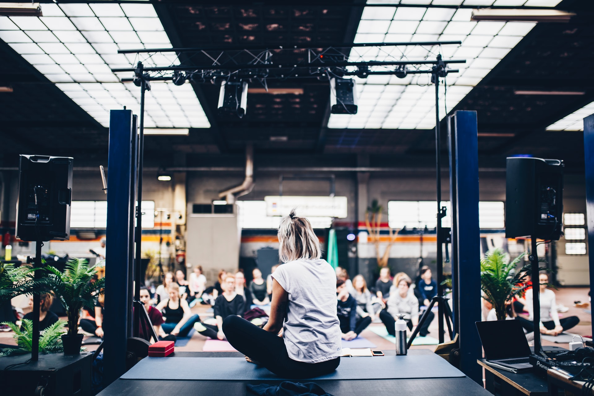 Woman delivering an event to people on yoga mats